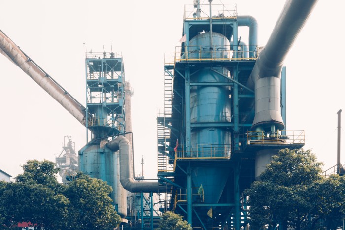 Industrial cooling tower and processing plant with large steel pipelines for efficient industrial cooling operations.