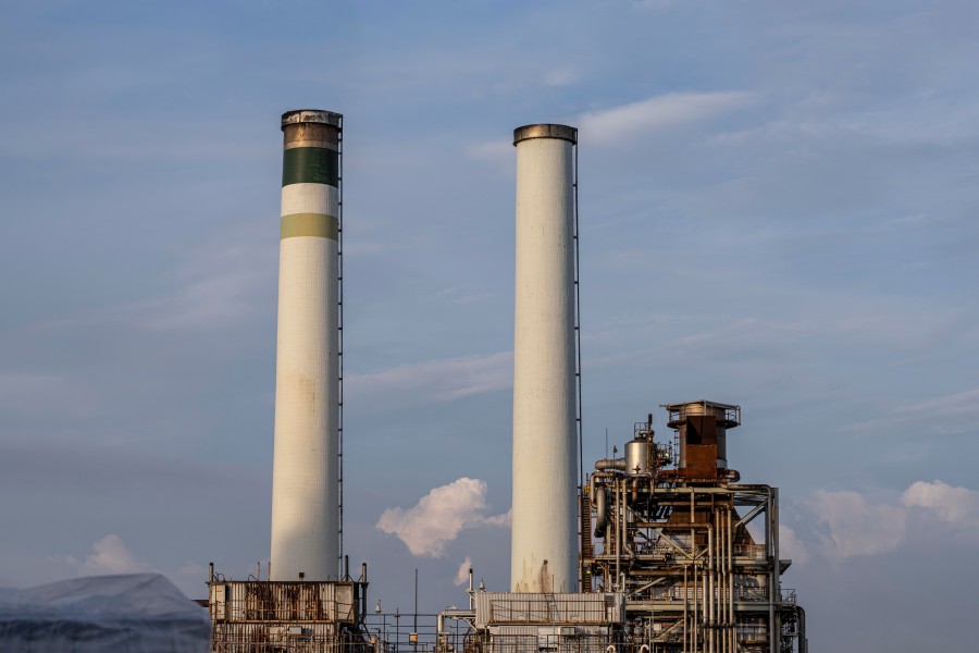 Industrial cooling tower facility with large chimneys and processing equipment