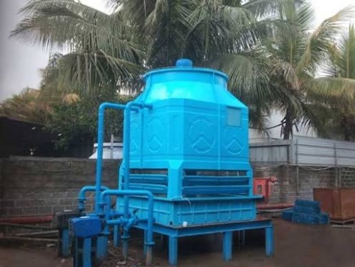 FRP Cooling Tower installed outdoors with blue piping and industrial cooling system components.