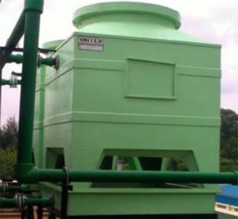 FRP Cooling Tower installed outdoors with green casing and connected piping