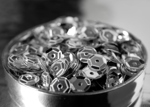 Cooling Tower Spare Parts featuring shiny metallic components with reflective surfaces arranged in a round container.